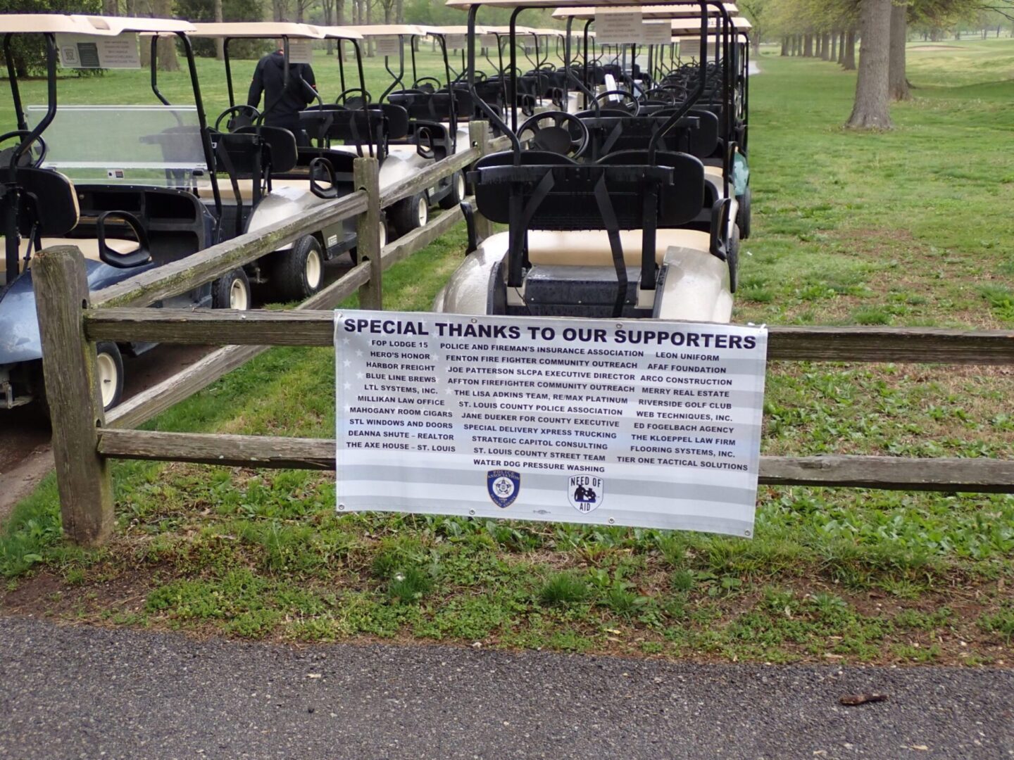 Sign listing special thanks to supporters at an outdoor event with goats.