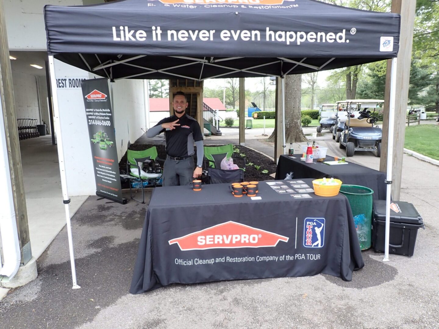 Promotional booth for SERVPRO with staff member ready to assist.