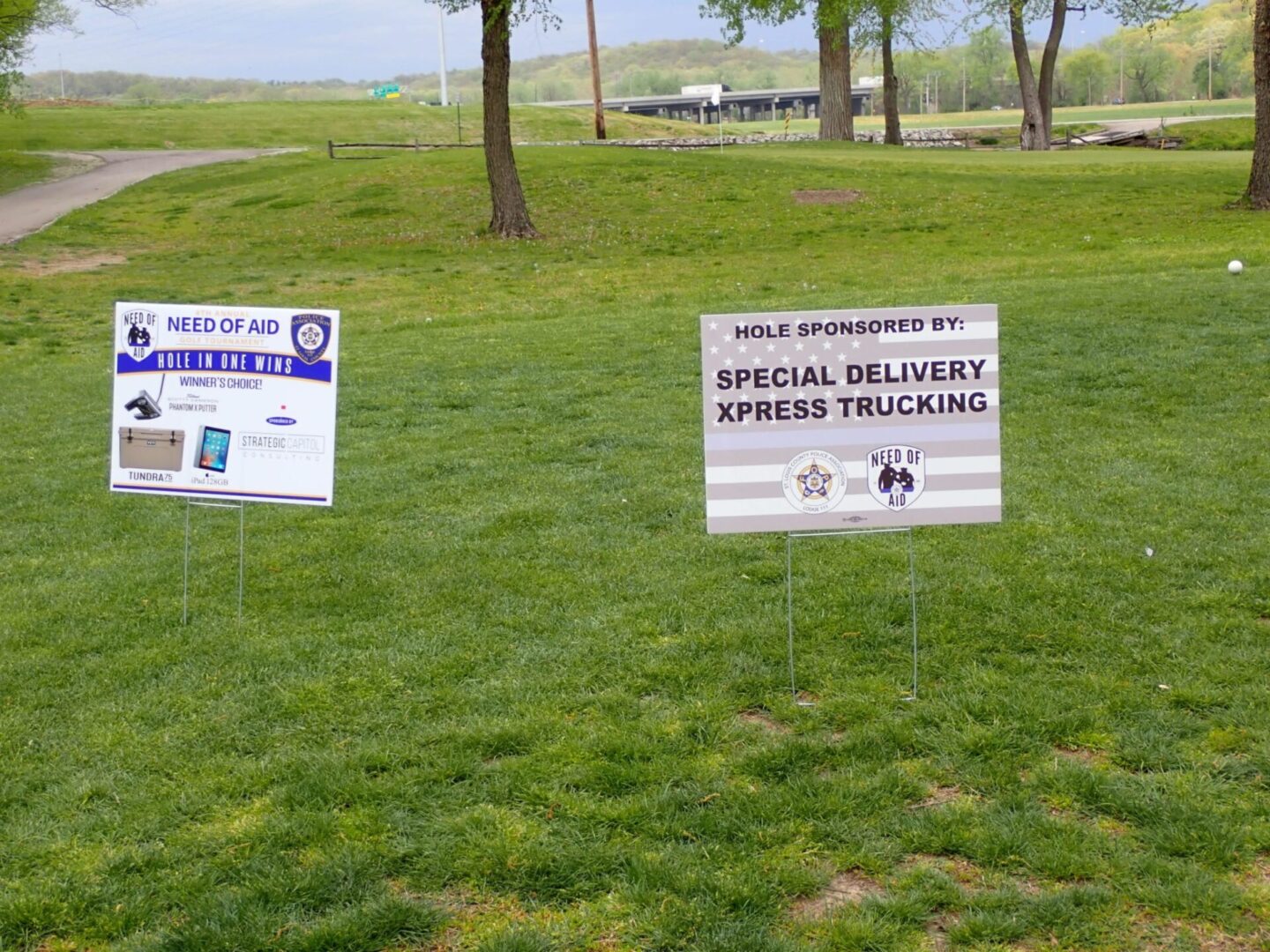 Signs in a park asking for special delivery appreciation.